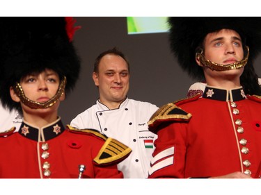 Chef Zsolt Varga from the Hungarian embassy smiles while he and his fellow chefs are introduced, with help from the Governor General's Foot Guards, at the second annual Embassy Chef Challenge held Thursday, November 5, 2015, at the John G. Diefenbaker Building on Sussex Drive, to raise funds to improve IBD care at the Children's Hospital of Eastern Ontario.