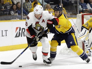 Nashville Predators defenseman Barret Jackman (5) defends Ottawa Senators right wing Chris Neil (25) during the first period.