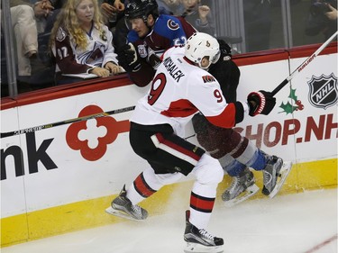 Ottawa Senators left wing Milan Michalek, fornt, of the Czech Republic, checks Colorado Avalanche right wing Chris Wagner during the first period of an NHL hockey game Wednesday, Nov. 25, 2015, in Denver.