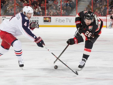 Matt Puempel #26 of the Ottawa Senators shoots the puck against Kevin Connauton #4 of the Columbus Blue Jackets.