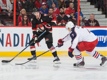 Kyle Turris #7 of the Ottawa Senators looks to pass the puck against Jack Johnson #7 of the Columbus Blue Jackets.
