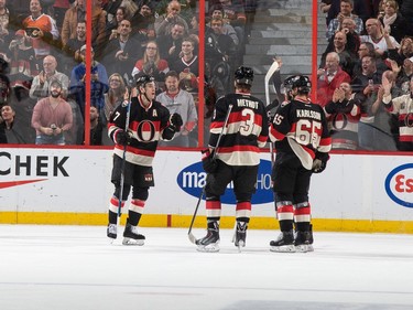 Erik Karlsson #65 of the Ottawa Senators celebrates his second goal of the game against the Columbus Blue Jackets with teammates Kyle Turris #7 and Marc Methot #3.