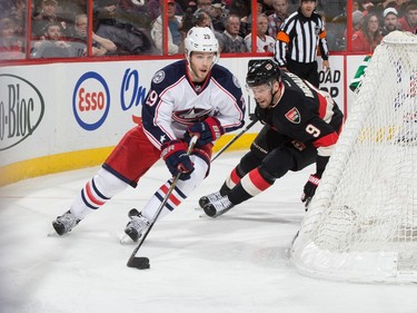 Milan Michalek #9 of the Ottawa Senators chases on the forecheck as Cody Goloubef #29 of the Columbus Blue Jackets skates the puck behind the net.