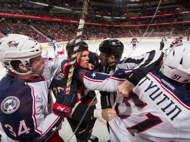 Chris Neil #25 of the Ottawa Senators gets involved in a scrum against Josh Anderson #34 and Fedor Tyutin #51 of the Columbus Blue Jackets after a whistle.