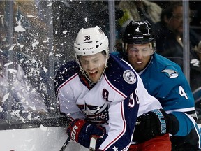 The Blue Jackets' Boone Jenner, seen crashing into the boards in front of San Jose's Brenden Dillon in a file photo, had a team-leading nine goals through the first 18 games of the season.