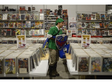 Cosplayer browses for a comic book at Pop Expo on Saturday, Nov. 21, 2015.