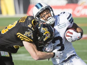 Toronto Argonauts running back Brandon Whitaker is tackled by Hamilton Tiger-Cats defensive back Craig Butler during the East semifinal in Hamilton on Sunday, Nov. 15, 2015. The Ticats won the game 25-22 and will be at TD Place stadium next Sunday to take on Ottawa in the East final.