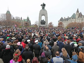 Crowds gather to place their poppies on the Tomb of the Unknown Soldier as the National Remembrance Day Ceremony takes place at the National War Memorial in Ottawa.