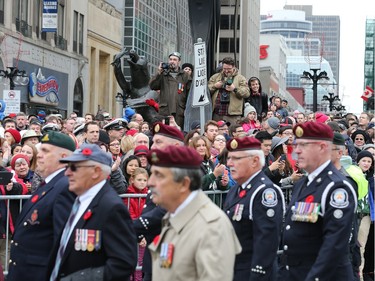 Crowds strain for a glimpse of the passing parade as the National Remembrance Day Ceremony takes place at the National War Memorial in Ottawa.