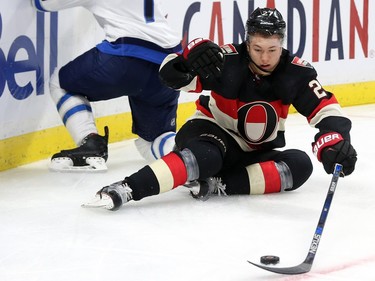 Curtis Lazar of the Ottawa Senators collides with Ben Chiarot of the Winnipeg Jets during first period NHL action.