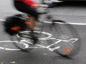 A cyclist on the Laurier Avenue segregated bike lane, one of just a few designated bike routes in downtown Ottawa.