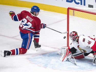 Montreal Canadiens' Dale Weise, left, scores on Ottawa Senators' goalie Craig Anderson during second period NHL action.