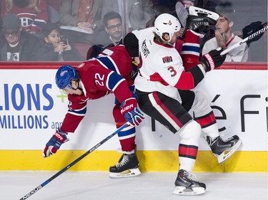 Montreal Canadiens' Dale Weise is checked into the boards by Ottawa Senators' Marc Methot during first period NHL action.