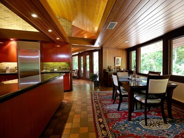 Originally the family room, the space beside the kitchen is now used as a breakfast nook. Even in the kitchen, little has changed, although appliances and the counter have been updated.