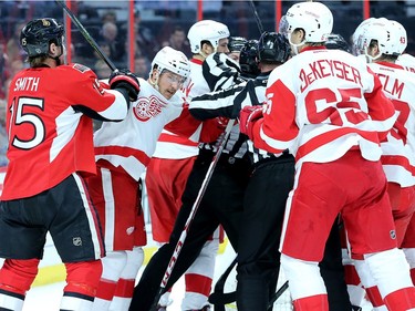 Detroit's Darren Helm gets upended in front of his own net, which led to a small skirmish during first period action between the Ottawa Senators (Zack Smith, at left), Chris Neil and Detroit  Red Wings Monday (Nov 16, 2015) at Canadian Tire Centre.