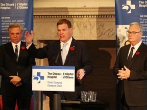 John Baird at the announcement of the  lease of 60 acres of the Experimental Farm to The Ottawa Hospital. Dr. Mark Kristmanson, CEO of the NCC, left, and Dr. Jack Kitts, CEO of The Ottawa Hospital, look on.