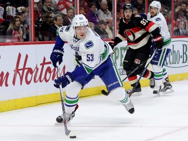 Vancouver player Bo Horvat skates with the puck.