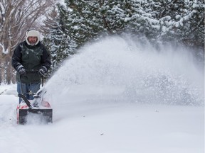 Greg Semenof clears snow off his sidewalk in Edmonton while in Ottawa we bask in double digit temperatures.