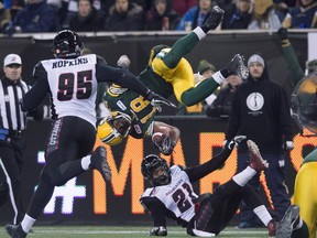 Edmonton Eskimos' Greg Morris flips over Ottawa Redblacks' Brandon Sermons during the second half of the103rd Grey Cup in Winnipeg, Man. Sunday, Nov. 29, 2015.