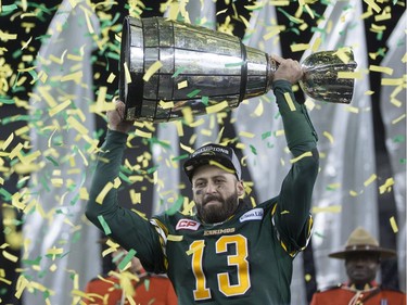 Edmonton Eskimos quarterback Mike Reilly hoists the Grey Cup after his teams win over the Ottawa Redblacks during the 103rd Grey Cup in Winnipeg, Man. Sunday, Nov. 29, 2015.