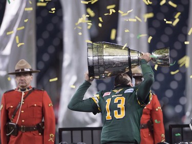 Edmonton Eskimos quarterback Mike Reilly hoists the Grey Cup after his teams win over the Ottawa Redblacks during the 103rd Grey Cup in Winnipeg, Man. Sunday, Nov. 29, 2015.