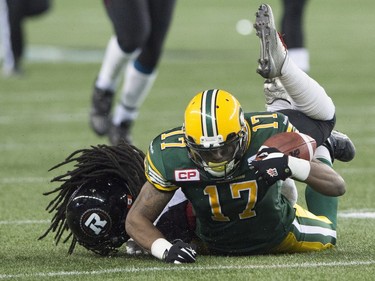 Edmonton Eskimos' Shamawd Chambers gets tackled by Ottawa Redblacks' Abdul Kanneh during the 103rd Grey Cup in Winnipeg, Man. Sunday, Nov. 29, 2015.