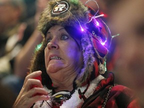 Fans get stressed as they watch a very close game between the Ottawa Redblacks and the Edmonton Eskimos on a big screen in the TD Place Arena in Ottawa during the 2015 CFL Grey Cup Sunday November 29, 2015.