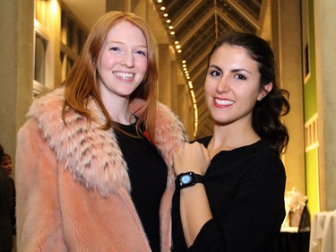 From left, Kimberley Todd modelled this mink and fox coat donated to the live auction by Ottawa's Pat Flesher Furs while Rebecca Dale sported an Apple watch, which was also sold off for charity at the Embassy Chef Challenge held Thursday, November 5, 2015, at the John G. Diefenbaker Building on Sussex Drive.