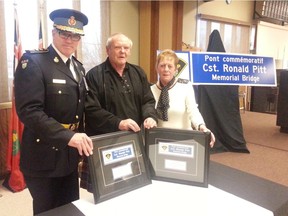 OPP Commissioner Vince Hawkes, Ronald Pitt Jr. and his wife Andrena are shown at a ceremony Friday to dedicate a Highway 401 bridge in honour of Pitt's father, Const. Ronald Pitt. Const. Pitt  died while duty with the former Morrisburg Police Force in 1957.