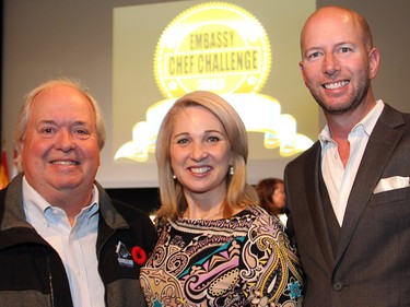 From left, prominent Ottawa real estate broker and charity auctioneer Kent Browne with Royal LePage sales representative Colleen McBride-O'Brien and Andrew Levitan, president of Larco Homes, at  the Embassy Chef Challenge held Thursday, November 5, 2015, at the John G. Diefenbaker Building on Sussex Drive, to raise funds toward a new IBD procedure room at CHEO.