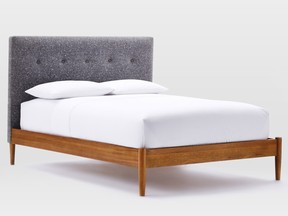 A button-tufted tweed headboard tops off this mid-century modern bed at westelm.com.