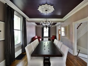 Painting the ceiling a dark colour adds drama and elegance, like the deep purple in the dining room and living room of this renovation project by Amsted Design-Build. (The colour is Sherwin Williams Raisin, SW-7630.)