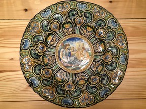 A charger plate dating to the early 20th century features an Italian design in maiolica, or tin-glazed pottery.