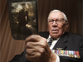 Gerald Bowen holds of picture of himself in his youth when he was a member of the Royal Canadian Navy while at Perley-Rideau Veteran's Health Centre Monday October 05, 2015.
