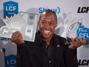 Redblacks quarterback Henry Burris poses for photographs after winning the CFL's most outstanding player award and Tom Pate memorial award during the Canadian Football League awards in Winnipeg on Thursday November 26, 2015.
