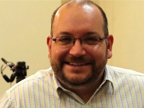 A file picture taken on September 10, 2013, shows Iranian-American Washington Post correspondent Jason Rezaian and his Iranian wife Yeganeh Salehi posing while covering a press conference at Iran's Foreign Ministry in Tehran. Rezaian, on trial for spying on Iran, began a second year behind bars on July 22, 2015, with his family increasingly concerned about his health.