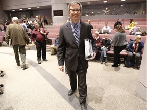 Jim Watson, mayor of Ottawa, walks with 2015 Ottawa city budge in council chambers Thursday November 12, 2015.