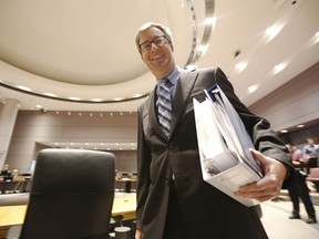 Jim Watson, mayor of Ottawa, walks with 2015 Ottawa city budget in council chambers Thursday November 12, 2015.