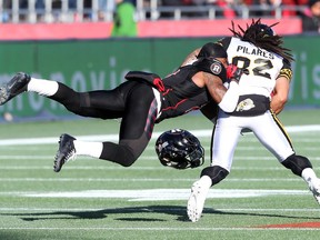 Jovon Johnson of the Ottawa Redblacks tackles Kealoha Pilares of the Hamilton Tiger-Cats during first half of the East Conference finals at TD Place in Ottawa, November 22, 2015. (Jean Levac/ Ottawa Citizen)