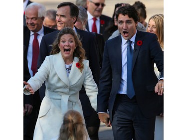 Justin Trudeau and his wife Sophie react to their children running to see them as they walk towards Rideau Hall.  (Wayne Cuddington/Ottawa Citizen)