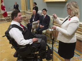 Governor General David Johnston and Prime Minister Justin Trudeau look on as Kent Hehr is sworn in as the Minister of Veterans Affairs and Associate Minister of National Defence during ceremonies at Rideau Hall Wednesday.