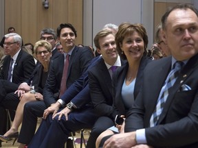 Prime Minister Justin Trudeau sits with Manitoba Premier Greg Selinger, Nova Scotia Premier Stephen McNeil, Ontario Premier Kathleen Wynne, Quebec Premier Philippe Couillard, New Brunswick Premier Brian Gallant, B.C. Premier Christy Clark, and Yukon Premier Darrell Pasloski as they listen to a question being asked during an information session at the First Ministers meeting at the Museum of Nature Monday November 23, 2015 in Ottawa.