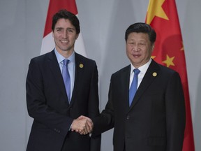 Prime Minister Justin Trudeau is greeted by Chinese President Xi Jinping as they take part in a bi-lateral meeting at the G20 Summit in Antalya, Turkey on Monday, November 16, 2015.