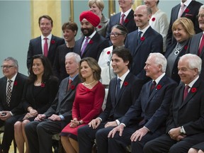 Governor General David Johnston joins Prime Minister Justin Trudeau and his new cabinet for a photo at Rideau Hall, in Ottawa, on Wednesday, Nov. 4, 2015.
