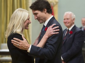 Prime Minister Justin Trudeau hugs Environment and Climate Change Minister Catherine McKenna at Rideau Hall in Ottawa on Wednesday, November 4, 2015.