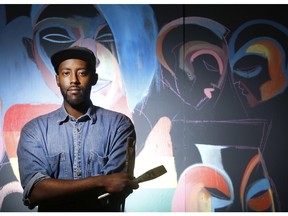 Kalkidan Assefa is photographed in front of his Black Lives Matter mural that he's repainting at the McNabb Recreation Centre Wednesday November 25, 2015 after the original one on Somerset St was defaced. Once completed, likely by the end of the month, it will hang outside the McNabb centre. (Darren Brown/Ottawa Citizen)
