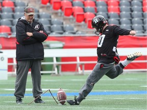 Kicker Chris Milo of the Ottawa Redblacks is observed by Special Team Co-ordinator, Don Yanowsky during practice at TD Place in Ottawa on Wednesday.