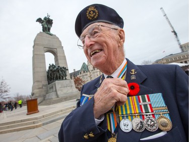 Korean War veteran E. Bruce Udle gets ready for the ceremony as the National Remembrance Day Ceremony takes place at the National War Memorial in Ottawa.