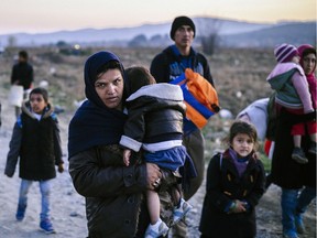 Refugees cross the Greek-Macedonian border.