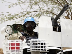 (FILES) -- A file photo taken on July 27, 2013 shows United Nations (UN) soldiers patrolling in the northern Malian city of Kidal. Two UN peacekeepers and a civilian contractor were killed in a rocket attack on November 28, 2015 on a UN base in northeast Mali, a week after a deadly siege at a Bamako hotel claimed by jihadists. "Our camp in Kidal was attacked early this morning by terrorists using rockets," said an official from the UN peacekeeping mission in Mali (MINUSMA), adding that two Guinean peacekeepers and a contractor working for the United Nations were killed. A local official confirmed the report.